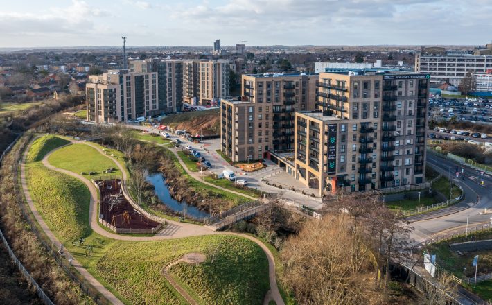 Aerial view of completed Watford Riverwell homes, the River Colne public realm and Watford General Hospital